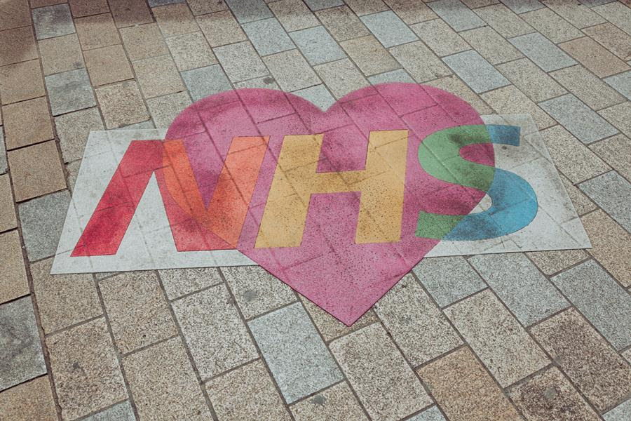 A heart painted on a street, with NHS written across it.